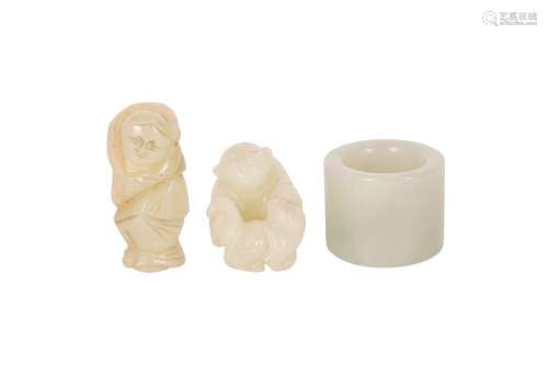 TWO CHINESE PALE CELADON JADE FIGURES AND AN ARCHER'S RI...