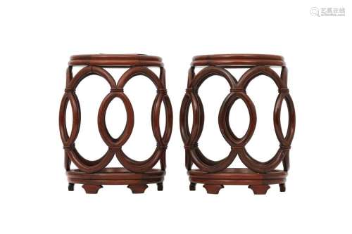A PAIR OF CHINESE WOOD RETICULATED BARREL STANDS.