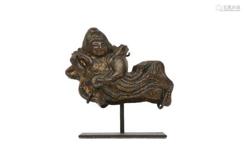 A CHINESE GILT-BRONZE PLAQUE OF A CELESTIAL MUSICIAN.