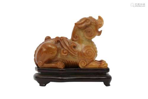 A CHINESE SOAPSTONE ARCHAISTIC 'MYTHICAL BEAST' CARV...