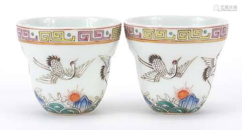 Pair of Chinese porcelain tea cups, each hand painted with c...