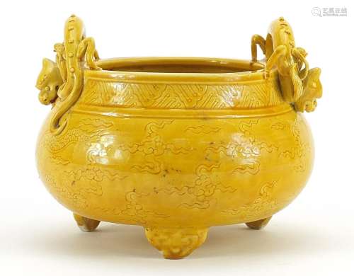 Chinese porcelain yellow glazed tripod censer with dragon ha...