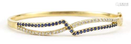 18ct gold diamond and sapphire crossover hinged bangle, 6.5c...