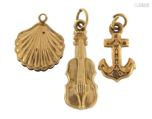 Three 9ct gold charms of a violin, anchor and clam shell, th...