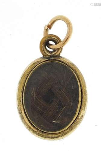 Antique gold coloured metal and enamel mourning locket, 1.5c...