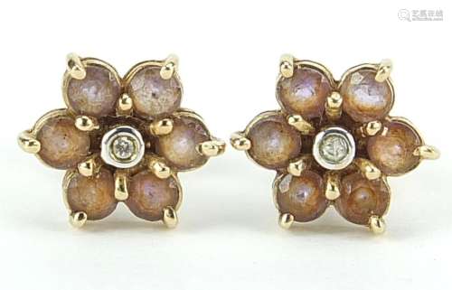 Pair of 9ct gold diamond and pink stone flower head stud ear...