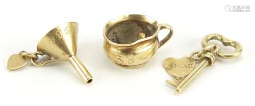 Three gold charms comprising chamber pot, wine funnel and ke...