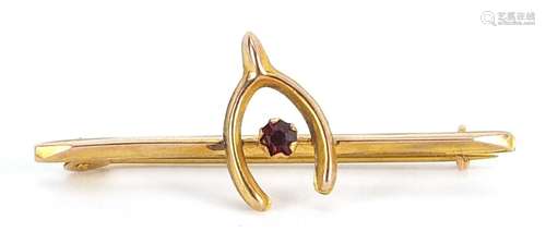 9ct gold wishbone bar brooch set with a red stone, 3.4cm wid...