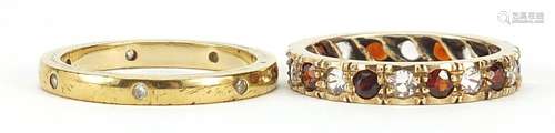 Two eternity rings, one 9ct gold set with clear and red ston...