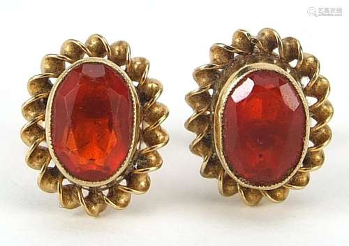 Pair of 9ct gold orange/red stud earrings possibly fire opal...