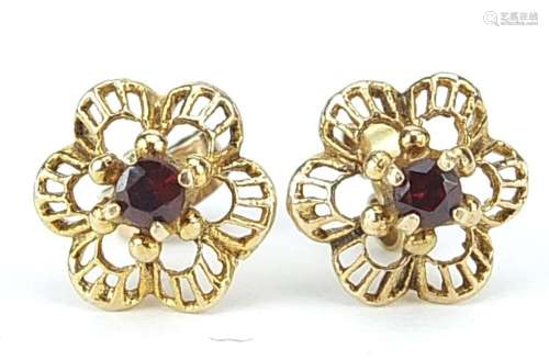 Pair of unmarked gold garnet flower head stud earrings, 1.1c...