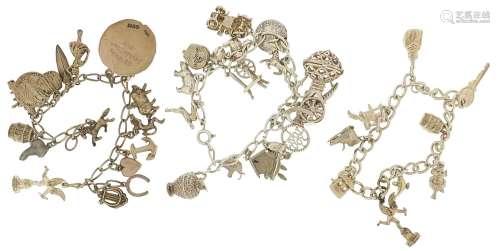 Three silver charm bracelets with a large selection of mostl...