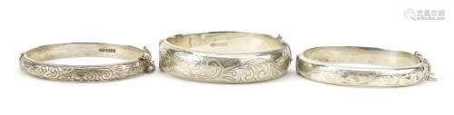Three silver hinged bangles with engraved decoration, 53.2g