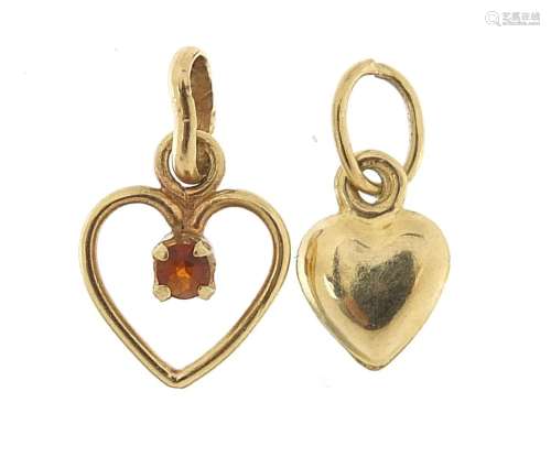 Two 9ct gold love heart charms, one set with a garnet, the l...