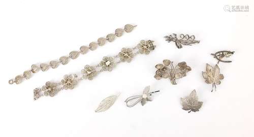 Seven silver brooches and two filigree silver bracelets, the...