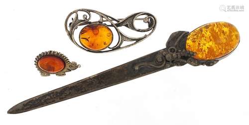 Silver and cabochon amber letter opener and two brooches, th...