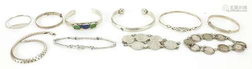 Silver and white metal jewellery including coin bracelets an...