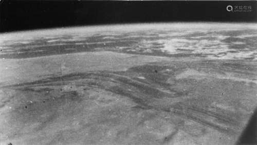 The first photograph of Earth taken with a handheld camera, ...