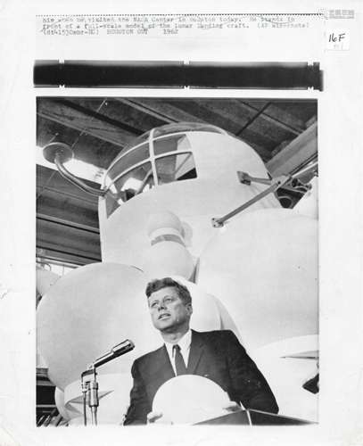 President John F. Kennedy with a scale model of the Apollo c...