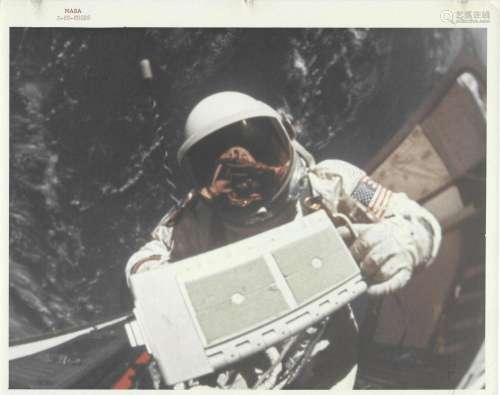 Buzz Aldrin with a micrometeoroid package in the open hatch ...