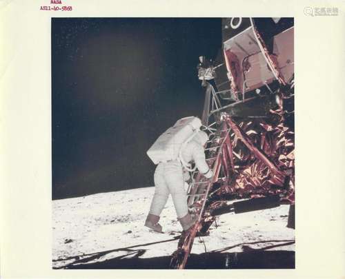 Buzz Aldrin descends from the ladder to walk on the Moon, Ap...