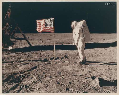 Buzz Aldrin beside the U.S. flag with his face visible insid...