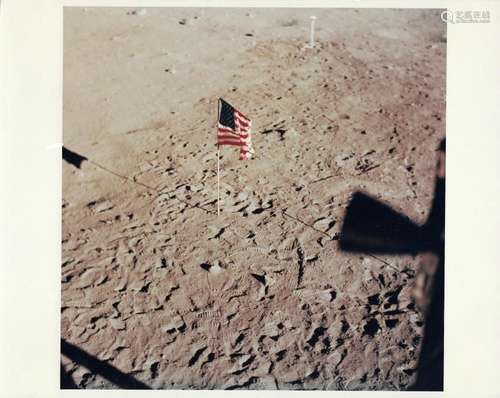 The first US flag surrounded by footprints seen from the Lun...