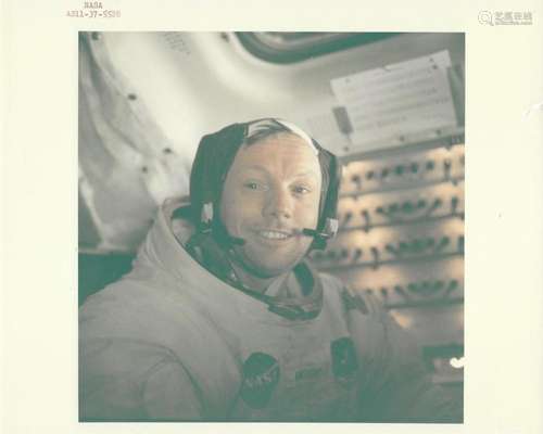 Neil Armstrong smiles inside the Lunar Module after the hist...