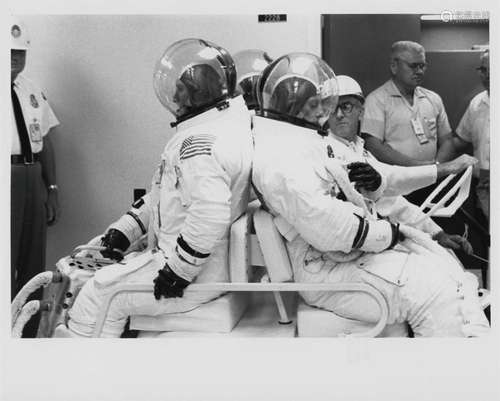 Unusual view of the Apollo 12 crew waiting to enter the alti...