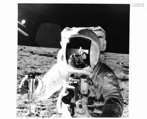 The celebrated visor portrait of Alan Bean with lunar soil s...