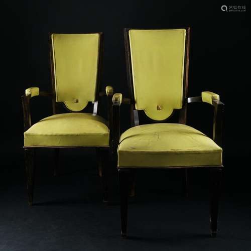 A pair of ebonized wood armchairs with high backs