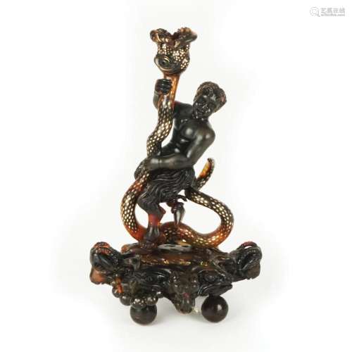 A totoiseshell partly piqué carved young satyr sculpure, pos...