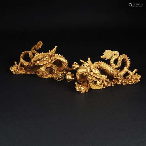 A pair of gilt bronze figures of a dragon, possibly China