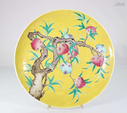 China large dish on a yellow background decorated with peach...