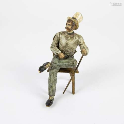 Viennese bronze Seated gentleman with chapeau buse and walki...