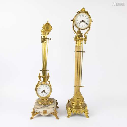 2 bronze mystery swinging clocks on a high column