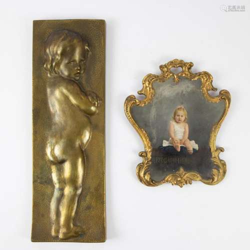 Bas relief in bronze of a little child and a painted photo o...