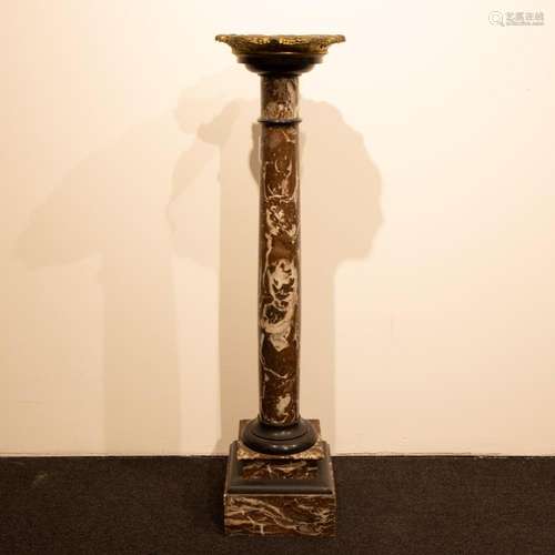 Marble pedestal with bronze top.