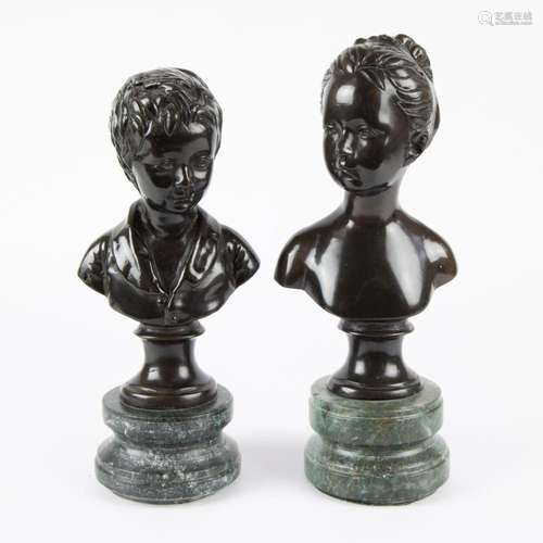 2 bronze busts of children on a marble base