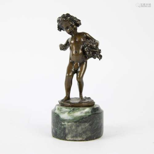 Bronze statue of an angel with grapes on marble stand.