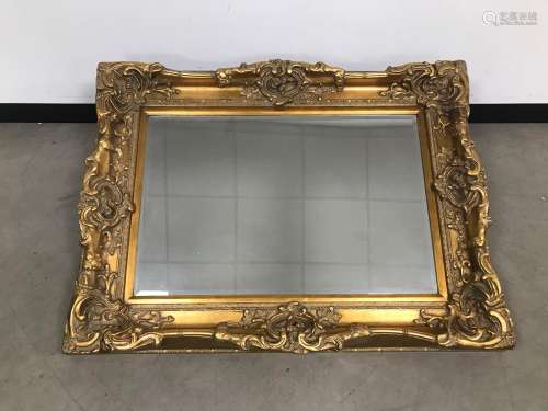 A modern and heavy gilt wall mirror, in the Louis XVI style,...