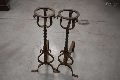 A pair of French mid-20th century wrought iron fire irons an...