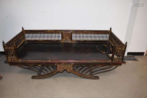 An early 20th Century Middle Eastern Opium bed, the hardwood...