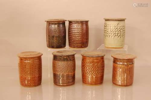 Seven stoneware studio pottery jars with lids, by Henry Stri...