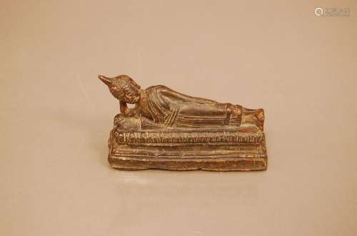A 19th century Far Eastern bronze figure of a recumbent Budd...