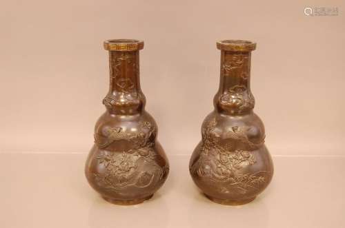 A pair of late Meiji period cast bronze vases, 31cm high, de...