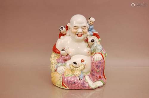 An early 20th century porcelain Chinese figure of a buddha w...