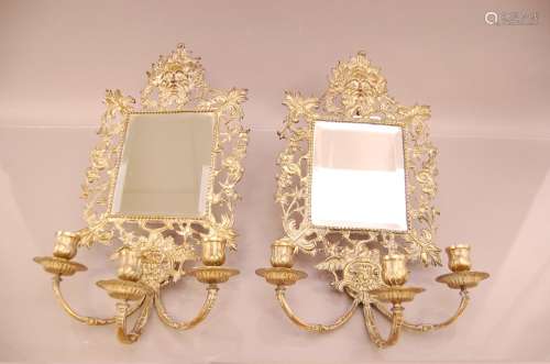 A pair of Victorian brass mirrored three branch wall sconces...