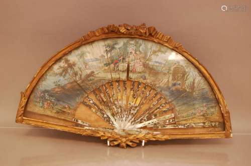 An 18th. Century paper fan, AF, in mother of pearl depicting...