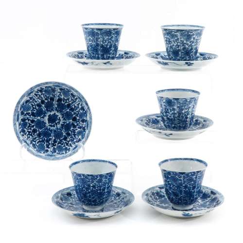 A COLLECTION OF BLUE AND WHITE CUPS AND SAUCERS